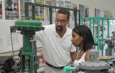 Professor Douglas and Student views Distillation Project on the AAS Campus